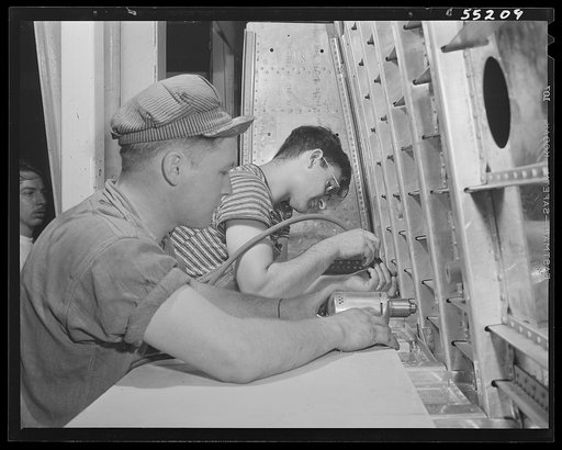 Kansas City, Kansas. Two men at work in the center section assembly of a B-25 bomber at North American Aviation, Inc.