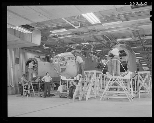 Kansas City, Kansas. Workmen assembling the bombadier's compartment and nose section of planes on the assembly line at North American Aviation, Inc.