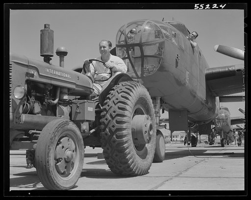 Kansas City, Kansas. B-25 bomber planes at North American Aviation, Inc., being hauled along an outdoor assembly line with an "International" tractor