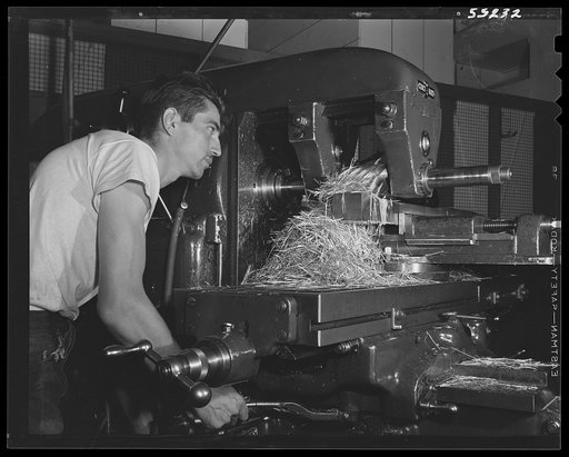 A mill operator in North American Aviation's huge machine shop turns out another of the thousands of parts for modern combat planes. All scrap metal is sent to salvage plant