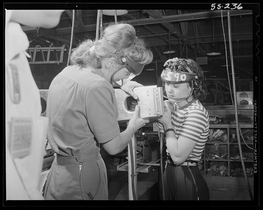 A section for the wing of a P-51 fighter is assembled by these two women employees at North American Aviation
