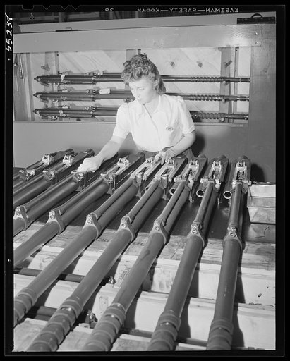Twenty mm cannon for North American's new P-51 fighter are checked over before moving to the final assembly line