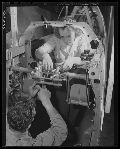 Inglewood, California. A man and woman working on rudder controls for a P-51 fighter plane at North American Aviation, Inc.