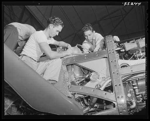 Final installations are made on a North American P-51 Mustang fighter on the final assembly line