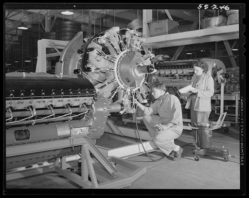 A huge motor for a North American B-25 bomber is given a last check in the motor department before moving to final assembly. Other motors are Allisons for P-51