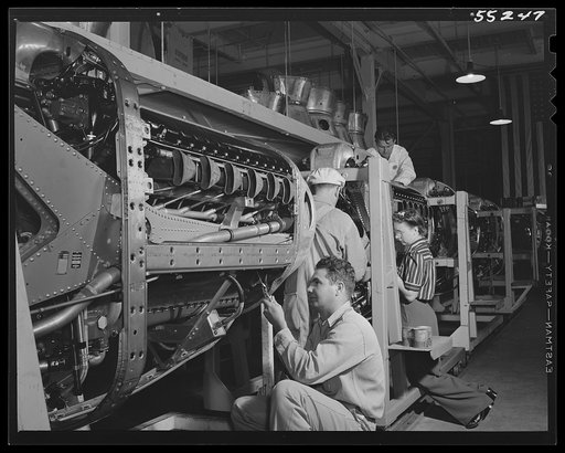 North American employees assemble the cowling on Allison motors for the P-51 fighters