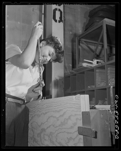 In the carpenter shop at North American, women employees assemble wood parts for B-25's and P-51 combat ships