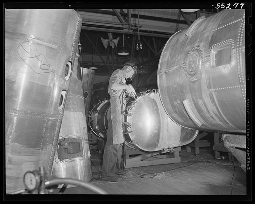 Tanks ready for final assembly surround this North American employee as he finishes another gasoline tank for a B-25 bomber