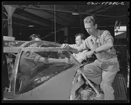 Employees in the enclosure department assemble the enclosures on the pilot's compartment of a North American B-25 bomber ("Lucite")