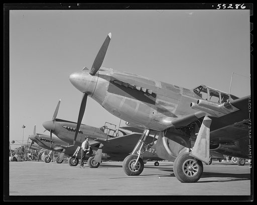 North American P-51 fighters await flight tests on the flight ramp. The P-51 is the Army Air Force's newest fighter