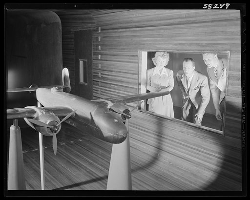 Engineers study the flight characteristics of a North American B-25 scale model in the wind tunnel