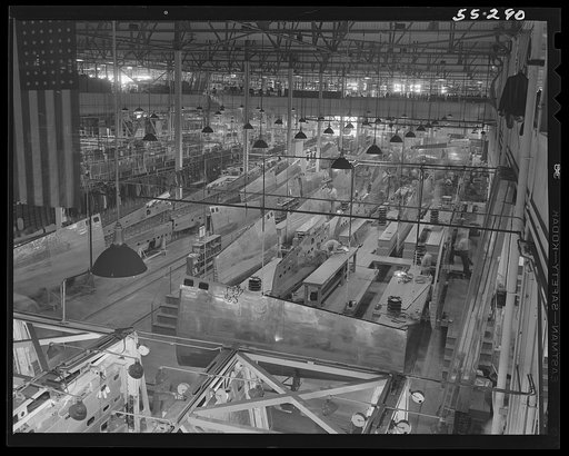 In the wing department at North American Aviation, wing sections move out of jigs onto long assembly lines