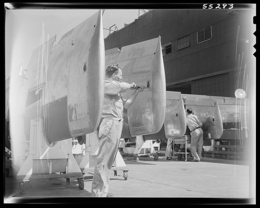 Final assemblies are put on wings for North American P-51 fighters before they move to the final assembly line