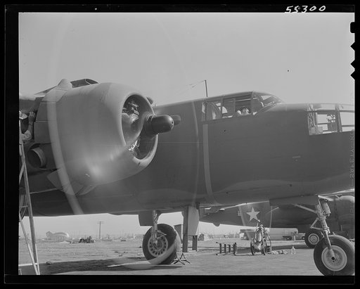 Motors on a North American B-25 bomber are warmed up before the plane takes off on its initial flight test