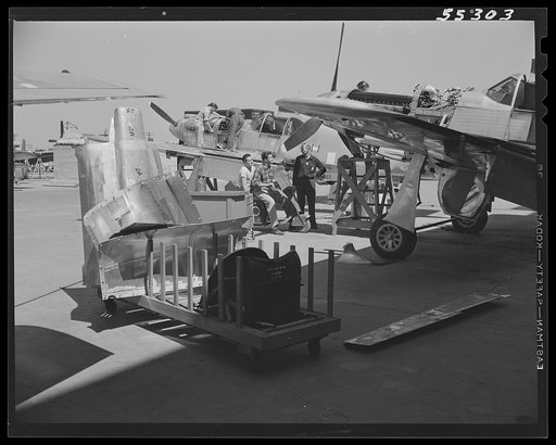 As North American P-51 fighters move off the final assembly line and on to the flight ramp, flight crews make final adjustments