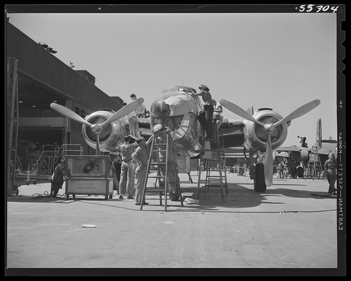 On North American's "Sunshine" assembly line, a B-25 bomber is prepared for painting. Paper is taped to those areas not to be painted