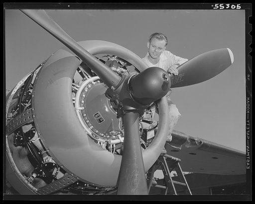 The motor of a North American B-25 bomber is given final adjustment before motor run-up