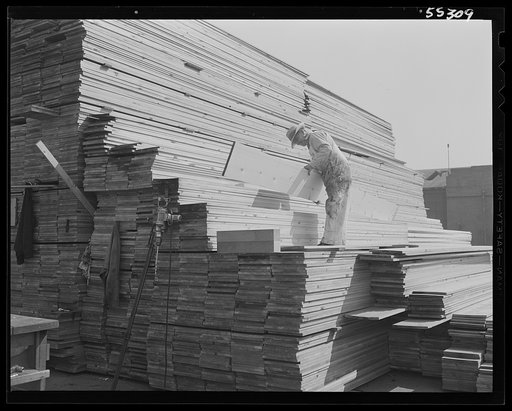 Lumber for shipping vital planes and parts to all the world is stacked next to the shipping department at North American Aviation