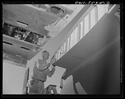 The outer wing panel is assembled to the center section of a North American B-25 bomber on the Sunshine Assembly Line