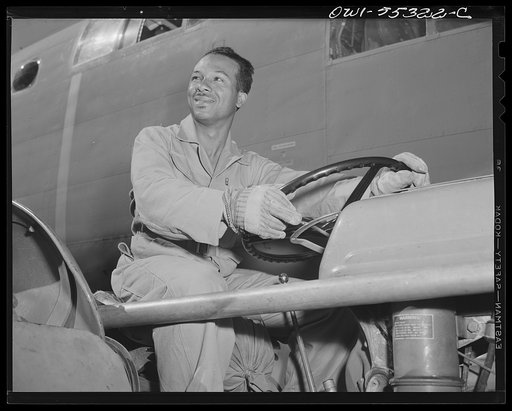 This Negro employee at North American Aviation tows planes into place on the flight ramp