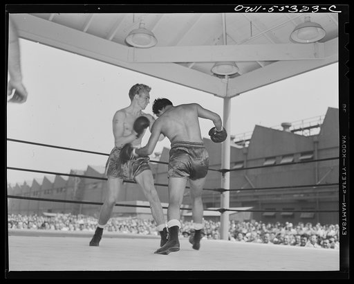 Two North American employees entertain their fellow workers with a boxing match during the lunch period recreation program