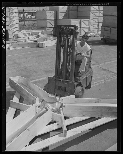 One of the huge propellers for a North American B-25 bomber is delivered from the receiving dock to the proper department for assembly