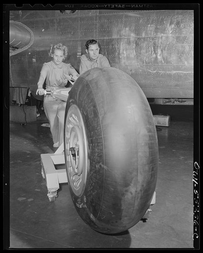 A landing gear ready for assembly on a North American B-25 is rolled into place on the final assembly line