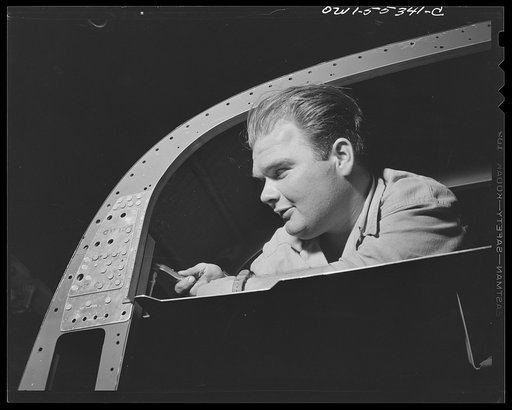 Joe Cobb, former "fat boy" in the original "Our Gang" comedy, now helps build North American B-25 bombers for the United Nations