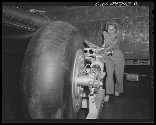 A landing gear ready for assembly on a North American B-25 is rolled into place on the final assembly line