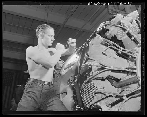 Cowling and controls are assembled on the motor of a B-25 bomber in the engine assembly department