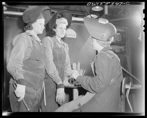 Women who are welders discuss the production of motor mounts and welded parts in their department