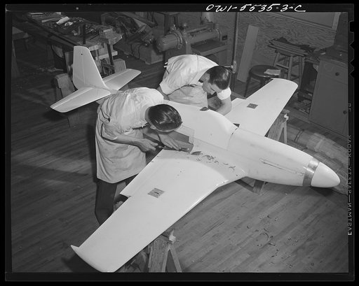 Inglewood, California. Two men in the model shop of North American Aviation, Inc., working on a model plane