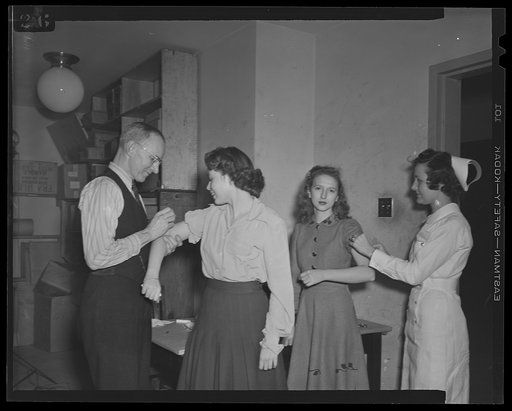 U.S. Office of War Information (OWI) employees receiving free inoculation against smallpox, diptheria and typhoid
