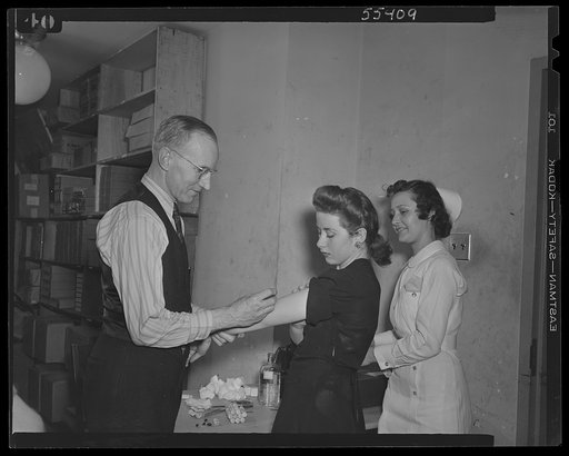 U.S. Office of War Information (OWI) employees receiving free inoculation against smallpox, diptheria and typhoid