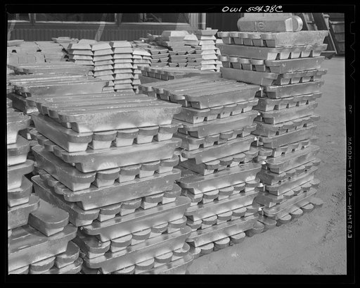 Untitled photo, possibly related to: Las Vegas, Nevada. Enormous asbestos mittens are worn by the worker handling the hot magnesium ingots produced at the Basic Magnesium Incorporated plant in the southern Nevada desert