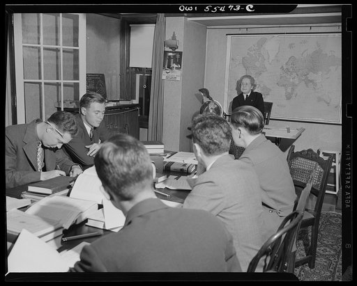 "Captain" Mary Converse, instructing V-7 (candidates for United States Navy ensign commissions) students in use of sextant, compass and gyroscope and in navigation. Classes are held in dining room