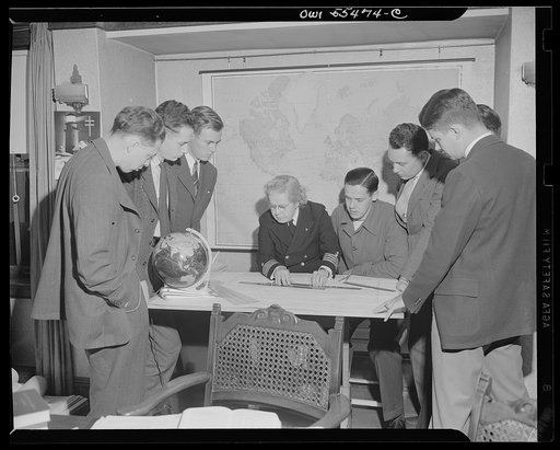 "Captain" Mary Converse, instructing V-7 (candidates for United States Navy ensign commissions) students in use of sextant, compass and gyroscope and in navigation. Classes are held in dining room