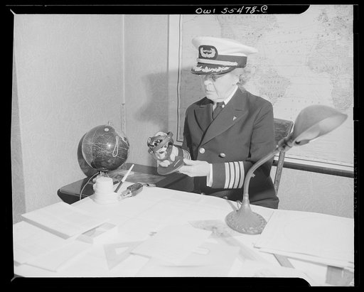 "Captain" Mary Converse, instructing V-7 (candidates for United States Navy ensign commissions) students in use of sextant, compass and gyroscope and in navigation. "Captain" Mary explaining the merits of gyroscope in navigation