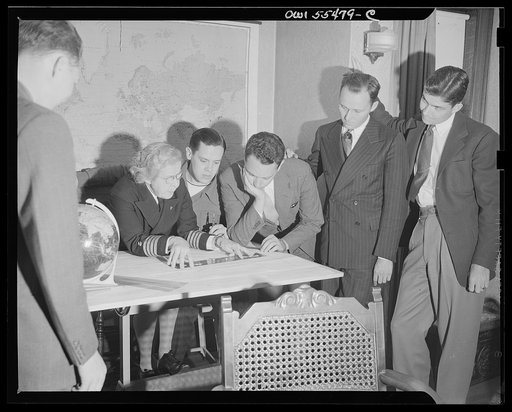 "Captain" Mary Converse, instructing V-7 (candidates for United States Navy ensign commissions) students in use of sextant, compass and gyroscope and in navigation. A problem in charting a course takes shape; every member of the class is keenly interested