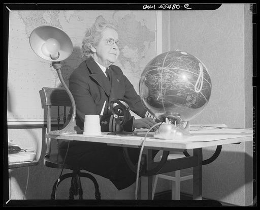 "Captain" Mary Converse, instructing V-7 (candidates for United States Navy ensign commissions) students in use of sextant, compass and gyroscope and in navigation. Captain Mary, the spirit of benovelence, looking at the class from behind her desk