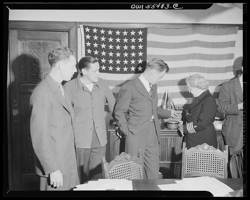 "Captain" Mary Converse, instructing V-7 (candidates for United States Navy ensign commissions) students in use of sextant, compass and gyroscope and in navigation. Captain Mary explaining the intricacies of the ship's compass
