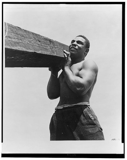 Negro laborers carrying and laying railroad ties for a spur line into a coal storage space for the federal government