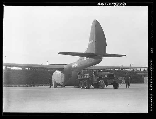 CG-10A. This experimental glider was developed to explore the feasibility of carrying very large equipment. It has the largest cargo space of any glider and the largest payload. Note size of truck which has just driven out of glider. Shown at demonstration of equipment held by United States Army Air