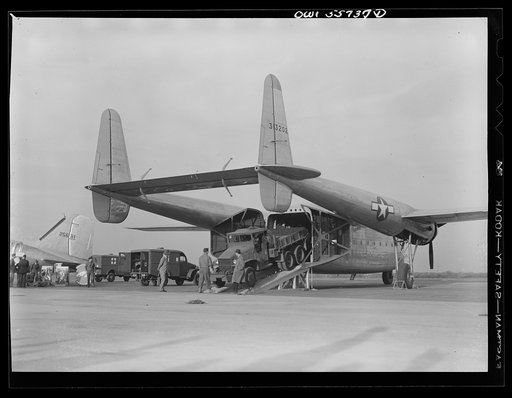 Large truck being driven off the Army Air Forces' new C-82 which was shown for first time at demonstration of equipment held by United States Army Air Forces. The special function of this plane is to land heavy military loads safely on rough fields near battle points. Its range exceeds 3,500 miles
