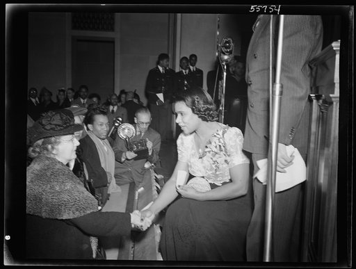 Marian Anderson greeting members of the audience at the ceremony held in the auditorium of the U.S. Department of the Interior at the dedication of a mural painting commemorating a free public concert given by her on the steps of the Lincoln Memorial on Easter Sunday, 1939
