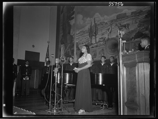 Marian Anderson at the ceremony held in the auditorium of the U.S. Department of the Interior at the dedication of a mural painting commemorating a free public concert given by her on the steps of the Lincoln Memorial on Easter Sunday, 1939
