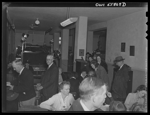 Arlington, Virginia. Citizens being checked to verify payment of poll tax and proper registration before receiving ballots for the national presidental election. A fire hose wagon is in the background of the firehouse where the voting is taking place