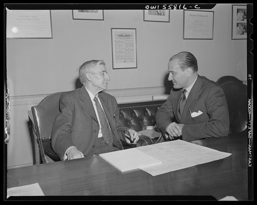 Washington, D.C. Mario Verdi (left), OWI (Office of War Information) radio commentator for Italy, visiting Assistant Postmaster General Perdum