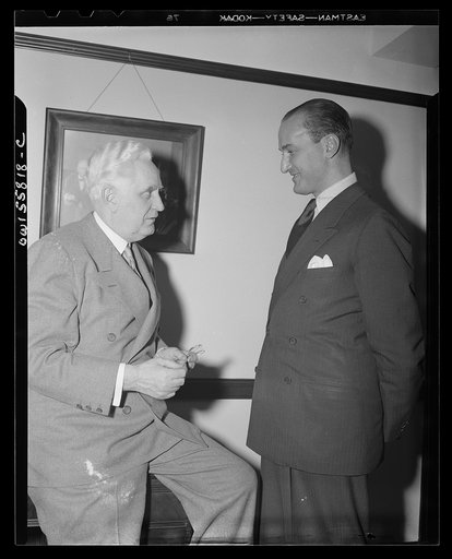 Washington, D.C. Mario Verdi (left), OWI (Office of War Information) radio commentator for Italy, visiting Mr. Leo Crowley, administrator of the Federal Economic Administration