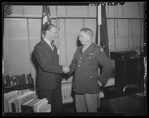 Washington, D.C. Mario Verdi (left), OWI (Office of War Information) radio commentator for Italy, visiting Provost Marshal General Brine